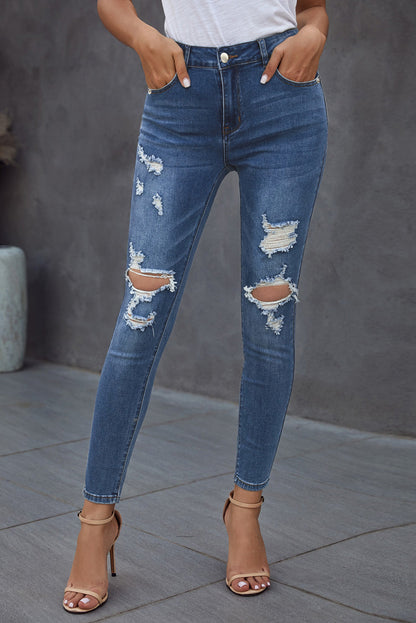 Blue hollow-out vintage skinny ripped jeans by Harlequin Daisy, showcasing distressed denim and slim fit design.