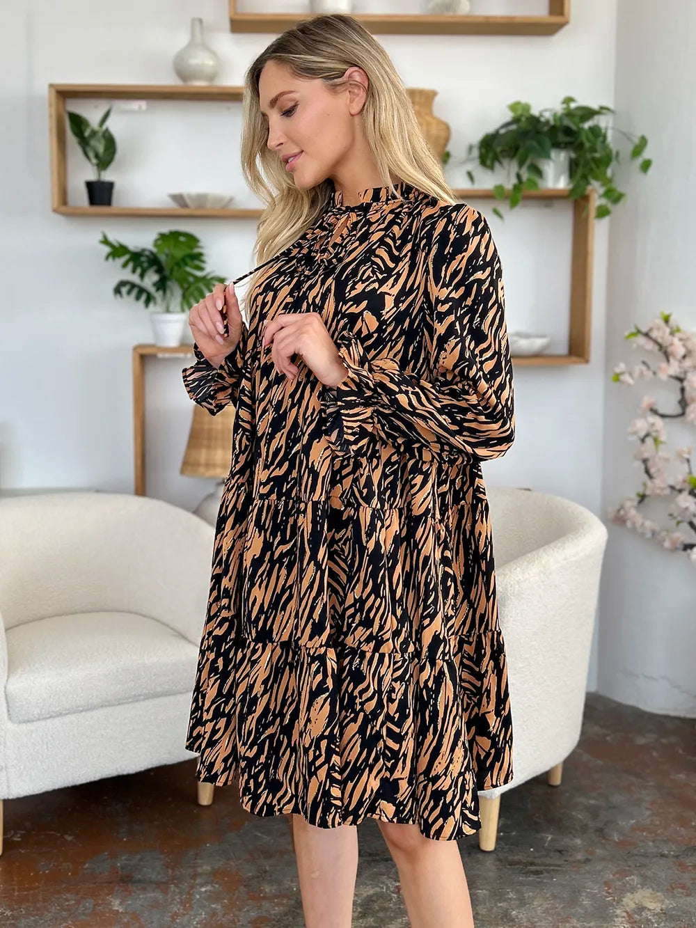 Pear Daisy Double Take printed ruffle hem long sleeve dress displayed in a home and garden setting, showcasing its stylish design.