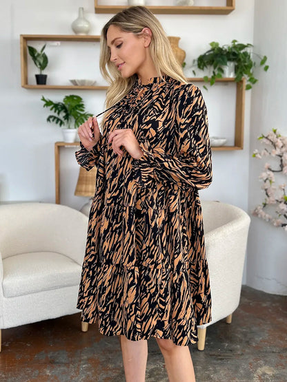 Pear Daisy Double Take printed ruffle hem long sleeve dress displayed in a home and garden setting, showcasing its stylish design.