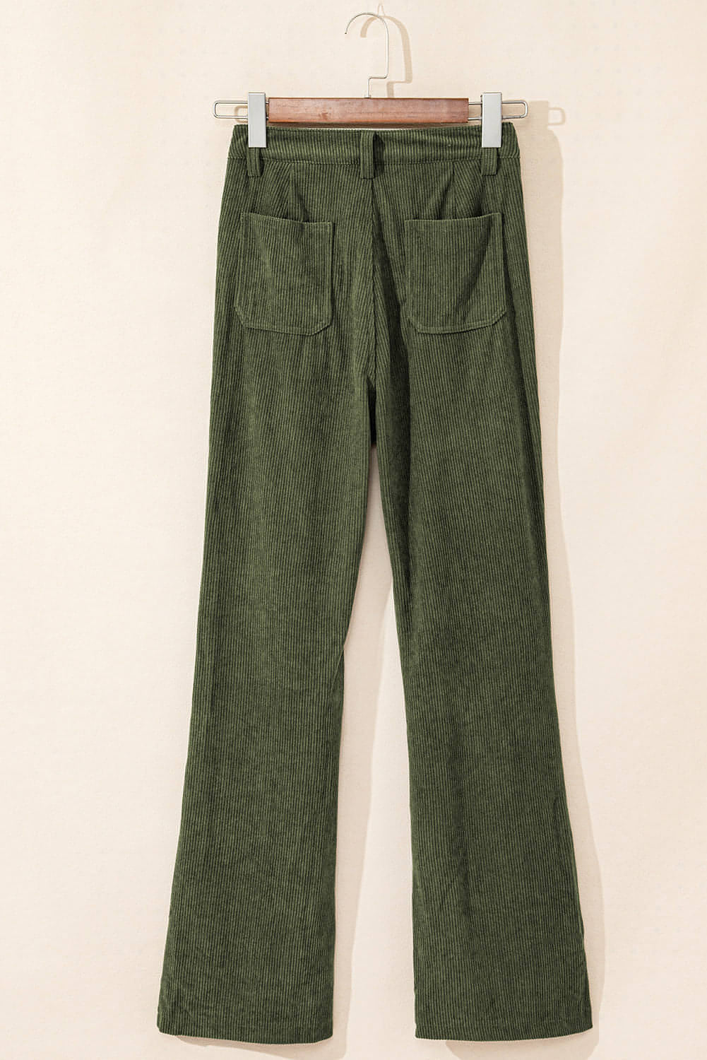 Green high waist corduroy pants with square pockets by Carmine Juneberry, shown on a model.