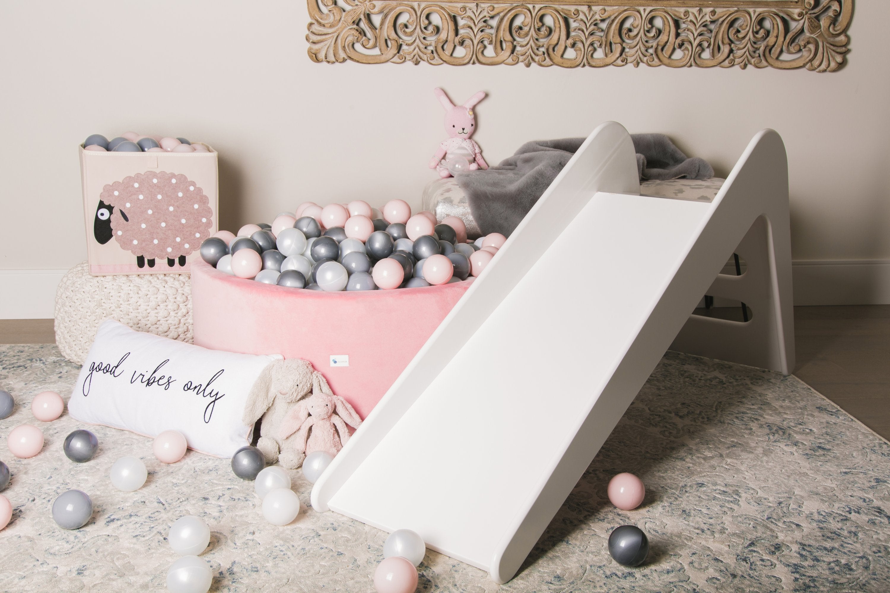 White wooden indoor slide for kids and babies by Rose Metis, featuring smooth polished surface and sturdy construction.