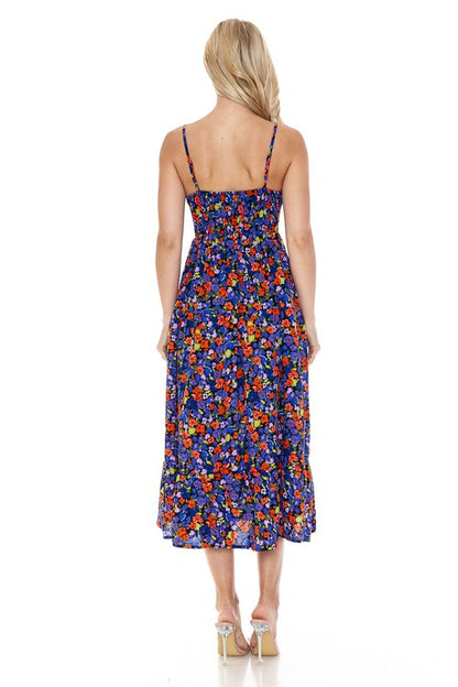Women’s floral maxi dress by Jade Icarus, flowing fabric with vibrant flower pattern, sleeveless design, perfect for summer wear.