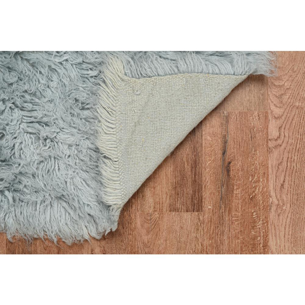 Light grey Flokati rug by Start2Finish, 5x8 feet with a soft, plush texture and 1400 grams weight, displayed on a floor.