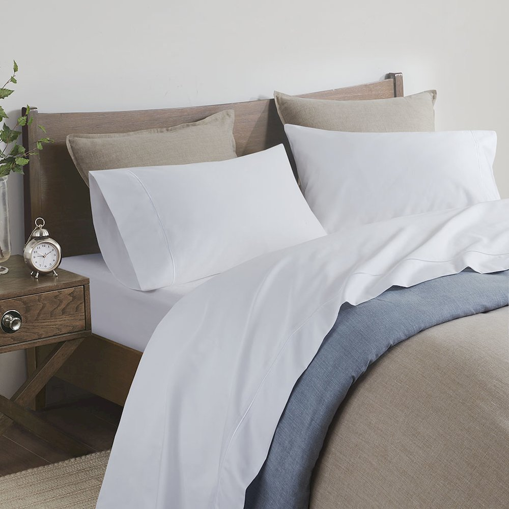 Start2Finish Pima Cotton Sheet Set with smooth, white sheets and pillowcases draped over a bed for comfortable bedding.