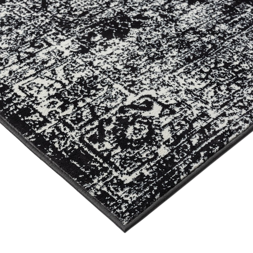 Distressed vintage Persian woven area rug with intricate patterns and muted colors, showcasing a distressed, aged look.