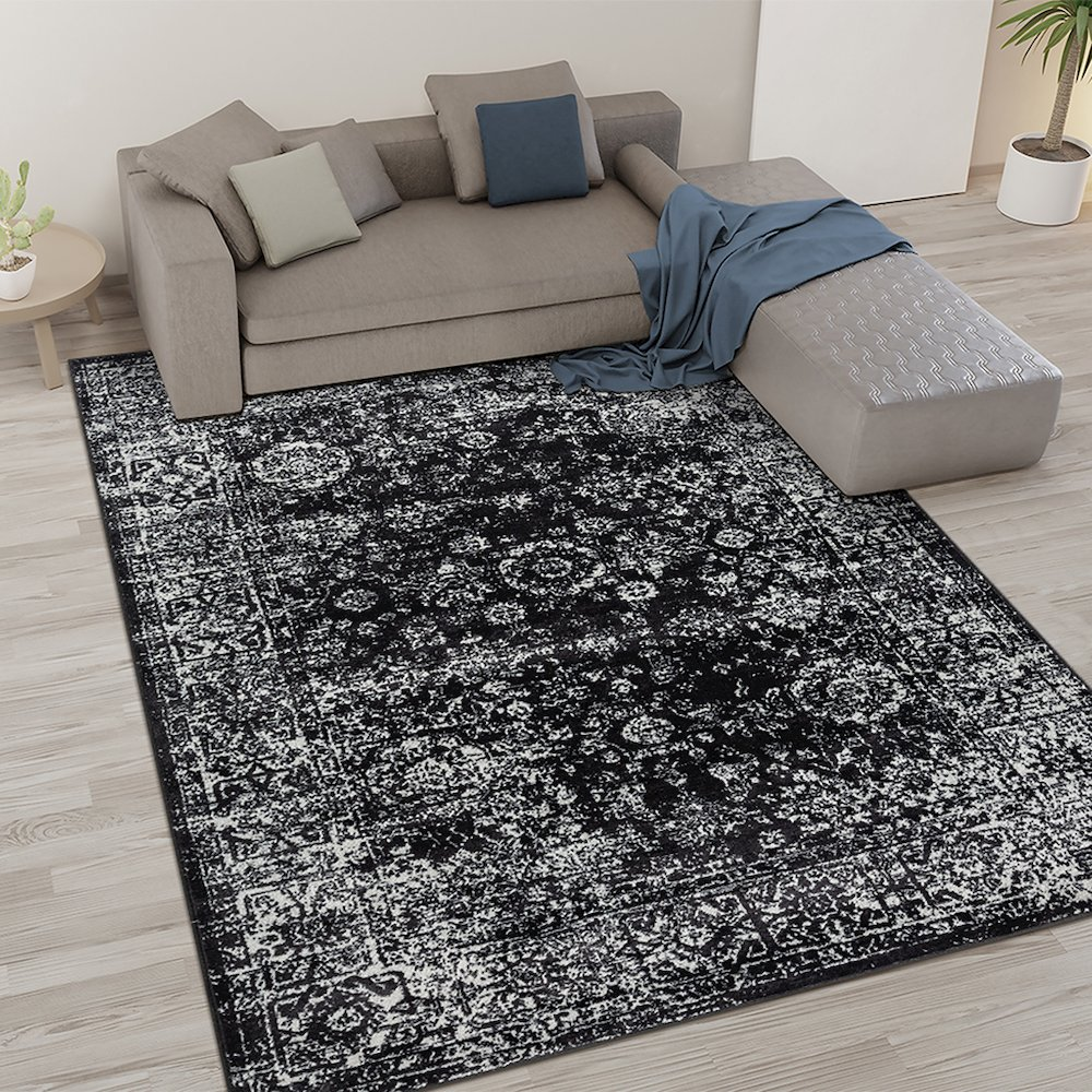 Distressed vintage Persian woven area rug with intricate patterns in muted tones, crafted by Start2Finish.