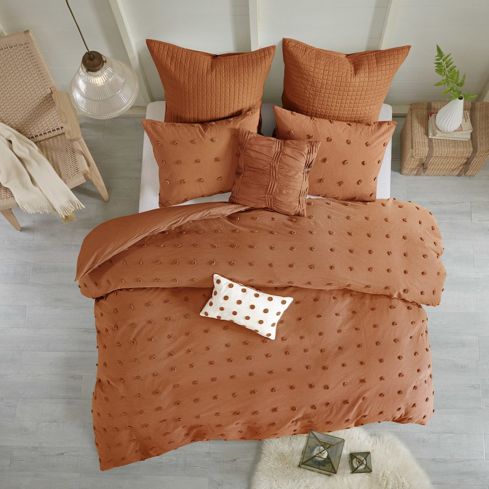 Cotton jacquard duvet cover set with euro shams and throw pillows, featuring intricate woven patterns in neutral tones.