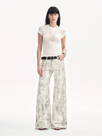 Brown Coeus "Phantom" snake print flared denim trousers, showcasing the textured snake pattern and stylish flared cut.