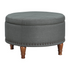 Alloway storage ottoman in charcoal fabric with antique bronze nailhead trim, featuring a padded lid and wooden feet.