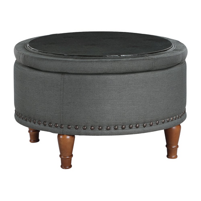 Alloway storage ottoman in charcoal fabric with antique bronze nailhead accents, featuring a cushioned top and storage space inside.