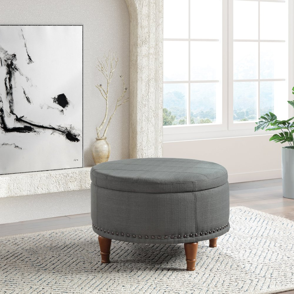 Start2Finish Alloway storage ottoman in charcoal fabric with antique bronze nailhead accents, showing its rectangular shape and tufted lid.