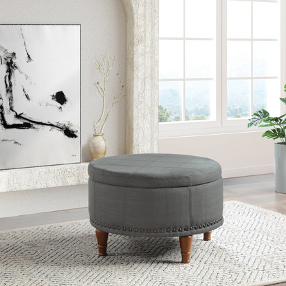Start2Finish Alloway storage ottoman in charcoal fabric with antique bronze nailhead accents, showing its rectangular shape and tufted lid.