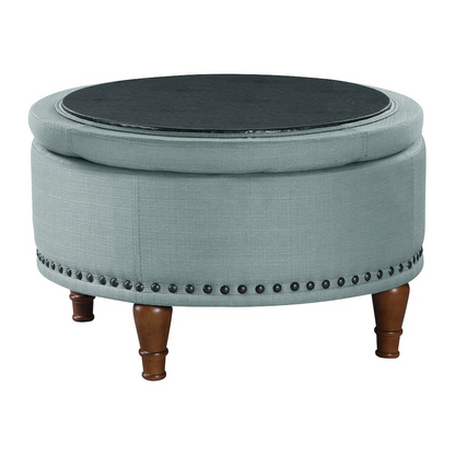 Alloway Storage Ottoman in Sea Blue fabric with antique bronze nailhead accents, showcasing its cushioned top and stylish design.