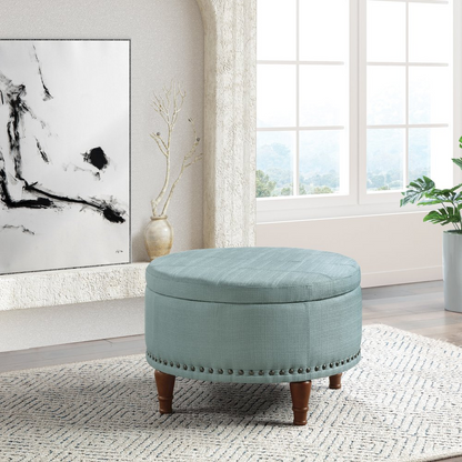 Start2Finish Alloway storage ottoman in sea blue fabric with antique bronze nailhead trim, showing its soft upholstery and decorative detailing.