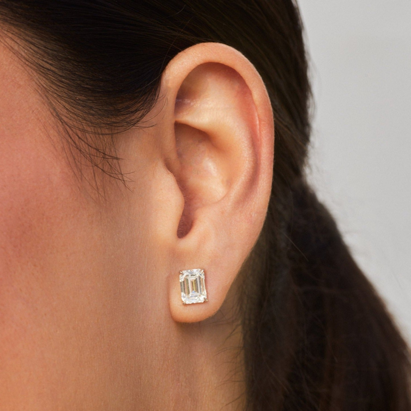 AGI Certified lab-grown emerald cut diamond stud earrings in 14K white gold, showcasing sparkling gemstones and elegant design