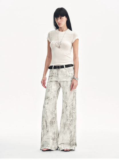 Brown Coeus Phantom snake print flared denim trousers with high waist and vibrant snake pattern on the fabric.