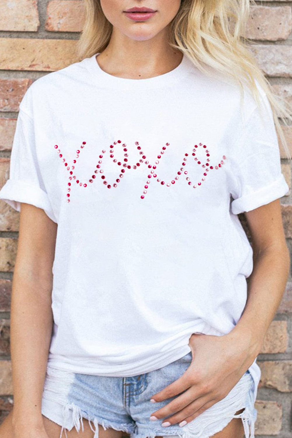 White rhinestone XOXO Valentine tee from Harlequin Daisy, featuring a stylish bath and beauty apparel design with rhinestone accents.