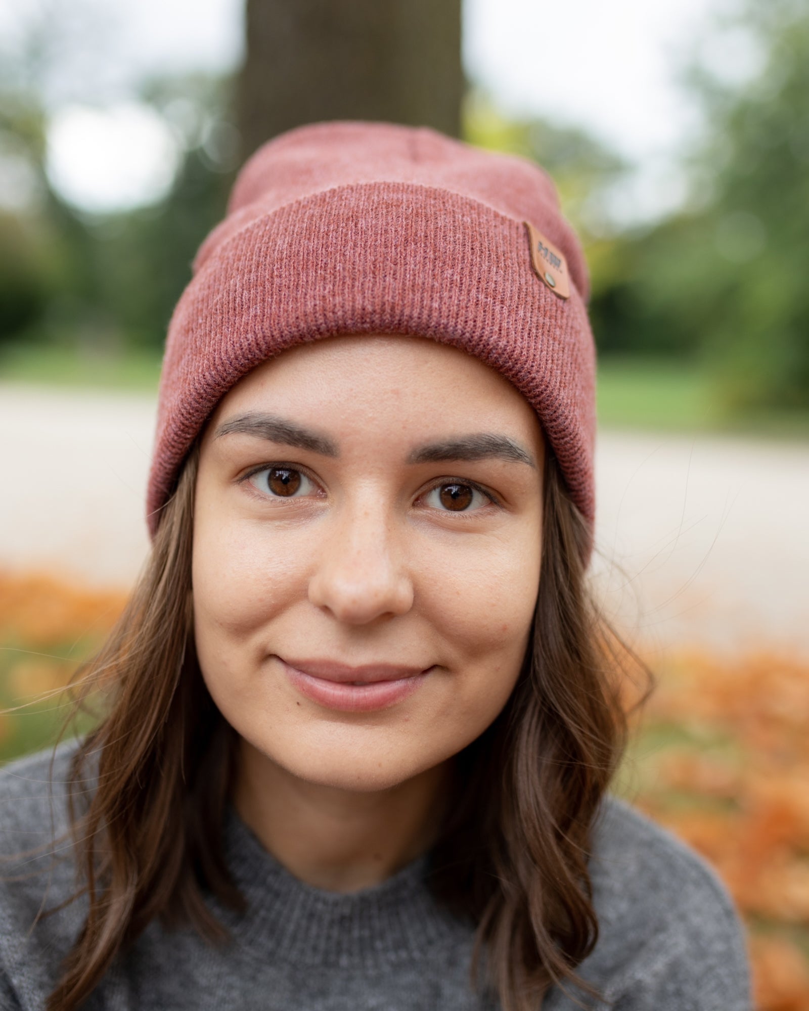 Azure Arrowwood HAAKWEAR Rusty Burgundy knit cuffed beanie hat with ribbed texture, cozy winter accessory.