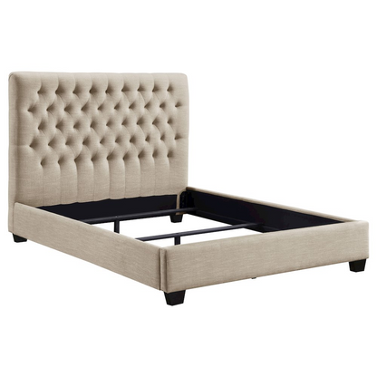 Chloe upholstered queen panel bed in oatmeal fabric with a padded headboard and wooden frame, styled in a modern bedroom setting.
