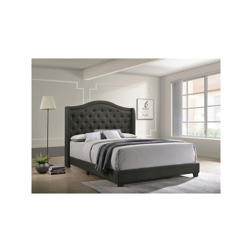 Grey Sonoma Upholstered Queen Wingback Bed with padded headboard and elegant design, shown from a side angle.