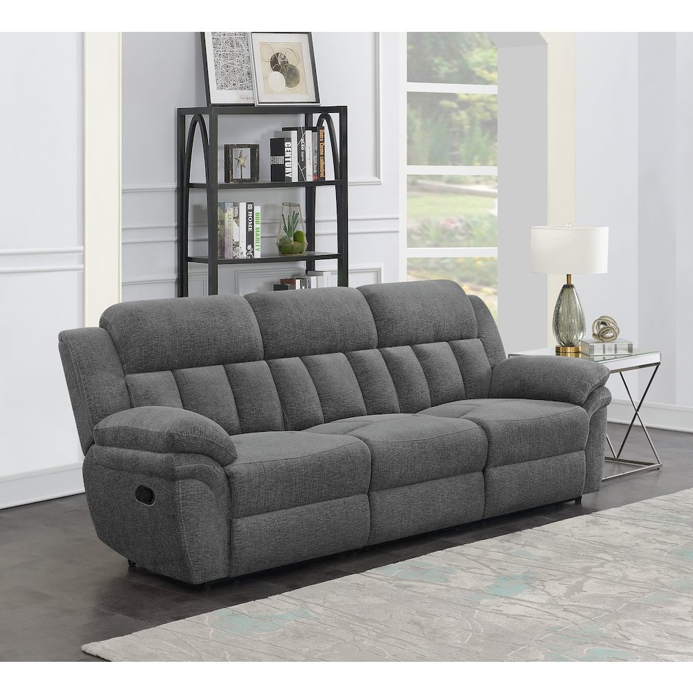 Charcoal Bahrain upholstered motion sofa by Start2Finish with plush cushions and modern design, shown in a living room setting.