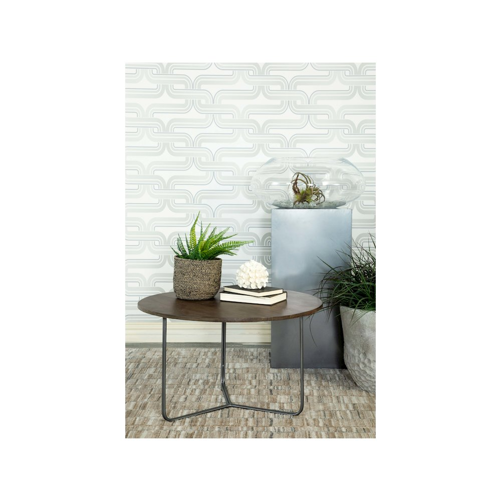 Yaritza round coffee table with mango wood top and gunmetal metal base, natural finish, in a modern living room setting