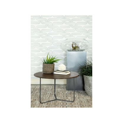 Yaritza round coffee table with mango wood top and gunmetal metal base, natural finish, in a modern living room setting