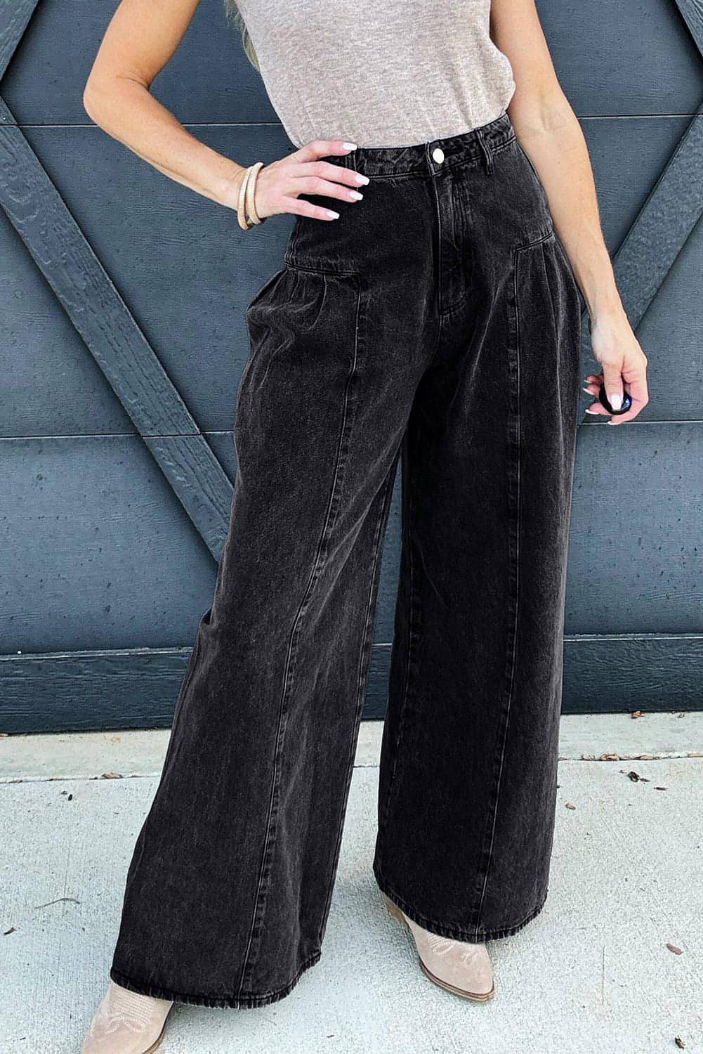 Dark grey pleated wide-leg denim pants by Carmine Juneberry featuring mineral wash finish and stylish, flowing silhouette.