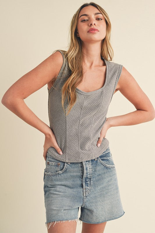 A Jade Icarus Aemi + Co Exposed Seam Ribbed Wide Strap Tank in automotive style, featuring textured fabric and wide shoulder straps.
