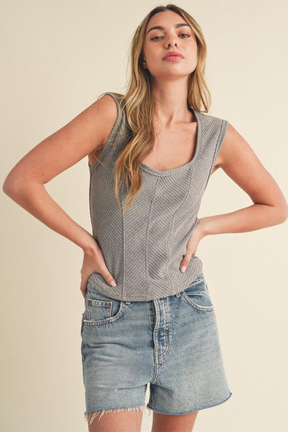A Jade Icarus Aemi + Co Exposed Seam Ribbed Wide Strap Tank in automotive style, featuring textured fabric and wide shoulder straps.
