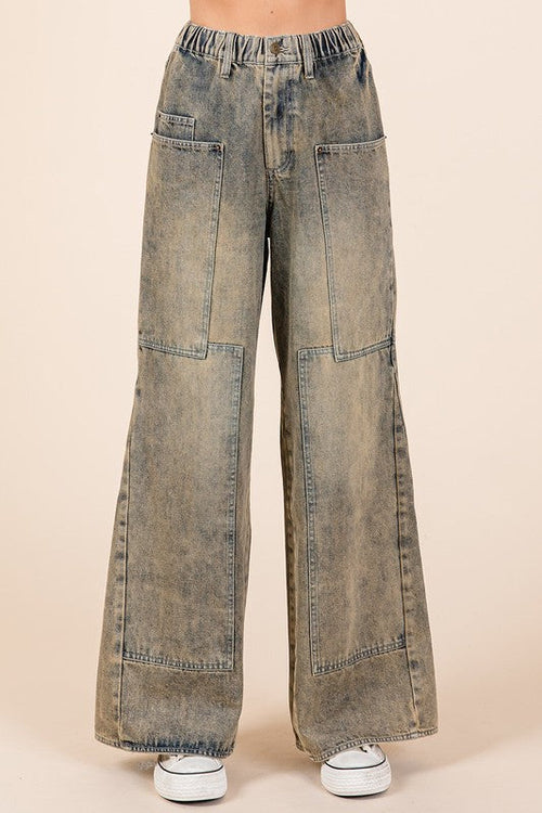 Jade Icarus Mittoshop washed wide-leg jeans with pockets, showcasing distressed denim and relaxed fit on a model.