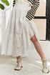 Jade Icarus ADORA elastic waistband tiered midi skirt, featuring flowing fabric and tiered design, shown in a fashion photo.