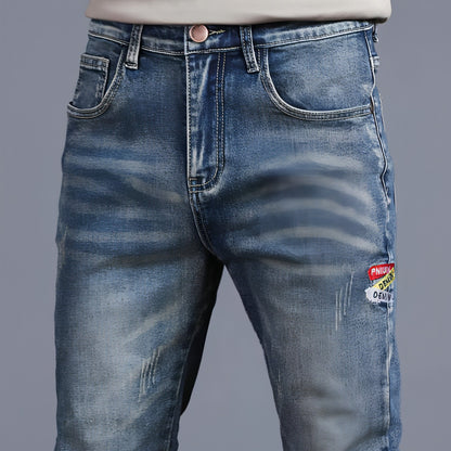 Youth retro embroidered denim pants for men by Carmine Juneberry, featuring classic denim fabric with detailed embroidery.