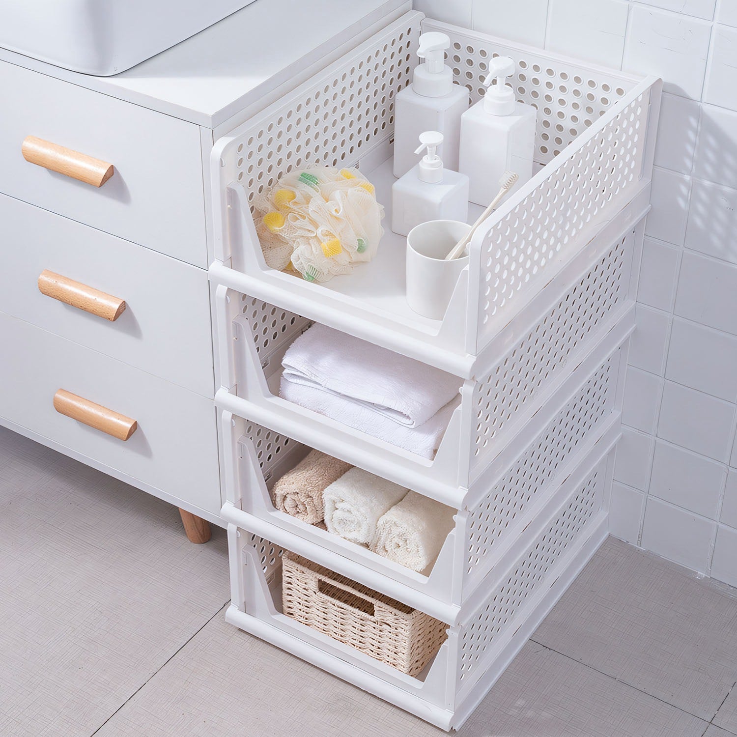 Four stackable Pear Daisy plastic storage boxes with slide rails, ideal for organizing living room or home storage.