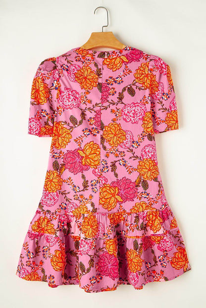 Pink floral bubble sleeve V-neck ruffled mini dress by Carmine Juneberry, featuring a fitted waist and playful ruffle details.