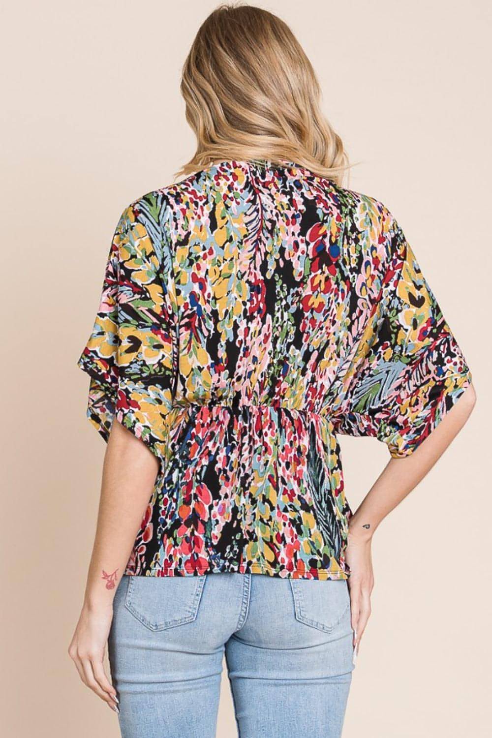 Carmine Juneberry BOMBOM printed surplice peplum blouse with long sleeves and floral pattern, shown on a model.