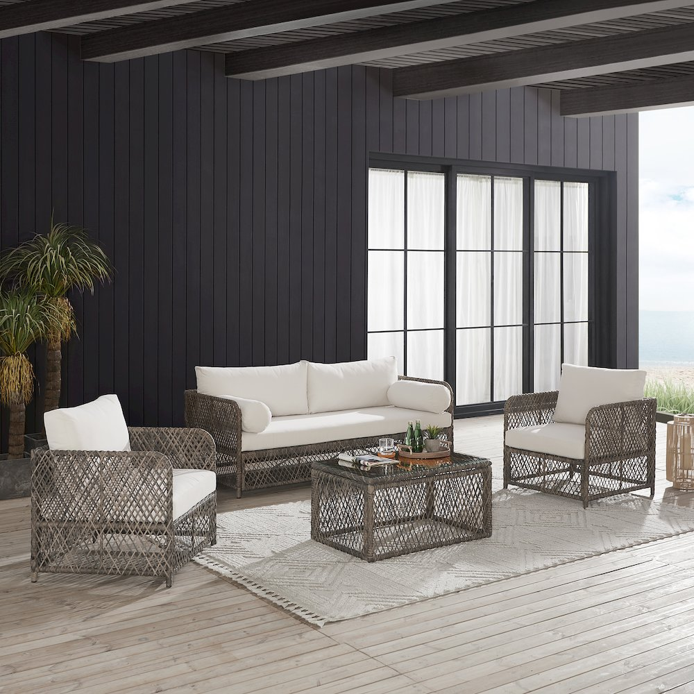 Start2Finish Granite Bay 4-piece outdoor patio sofa set with sofa, coffee table, and two chairs on a patio.
