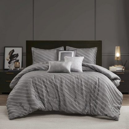 Start2Finish Riva 7-piece grey comforter set with matching pillow shams and decorative throw pillows on a bed.