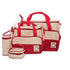 Raspberry Pallas 5-in-1 multifunctional baby bag in red dots, featuring denim material and multiple compartments for parents on the go.