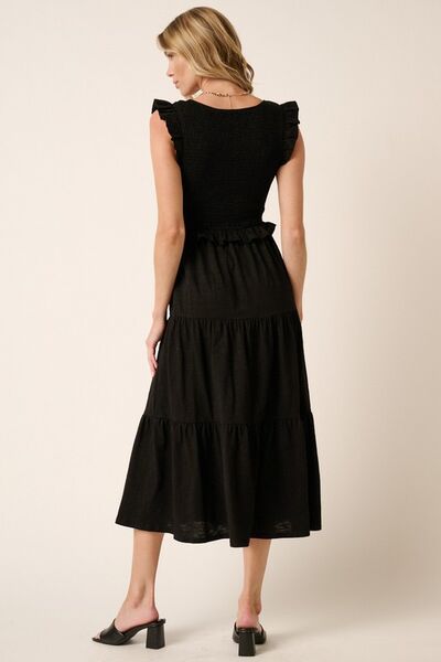 Automotive vehicle featuring a sleek Jade Icarus Mittoshop smocked ruffled tiered midi dress design.