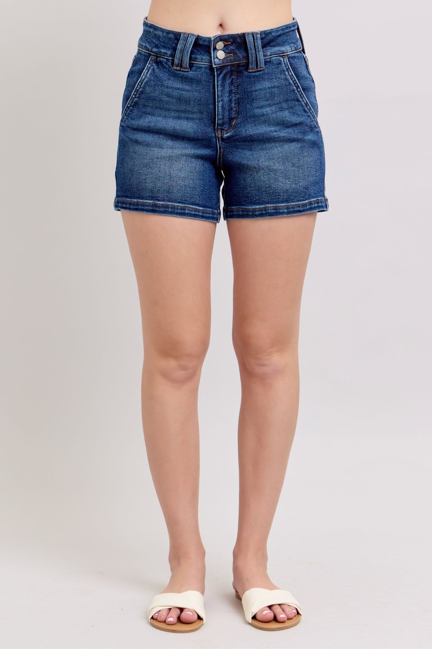 Judy Blue plus size denim shorts with double button waistband, featuring a classic blue wash and frayed hem.