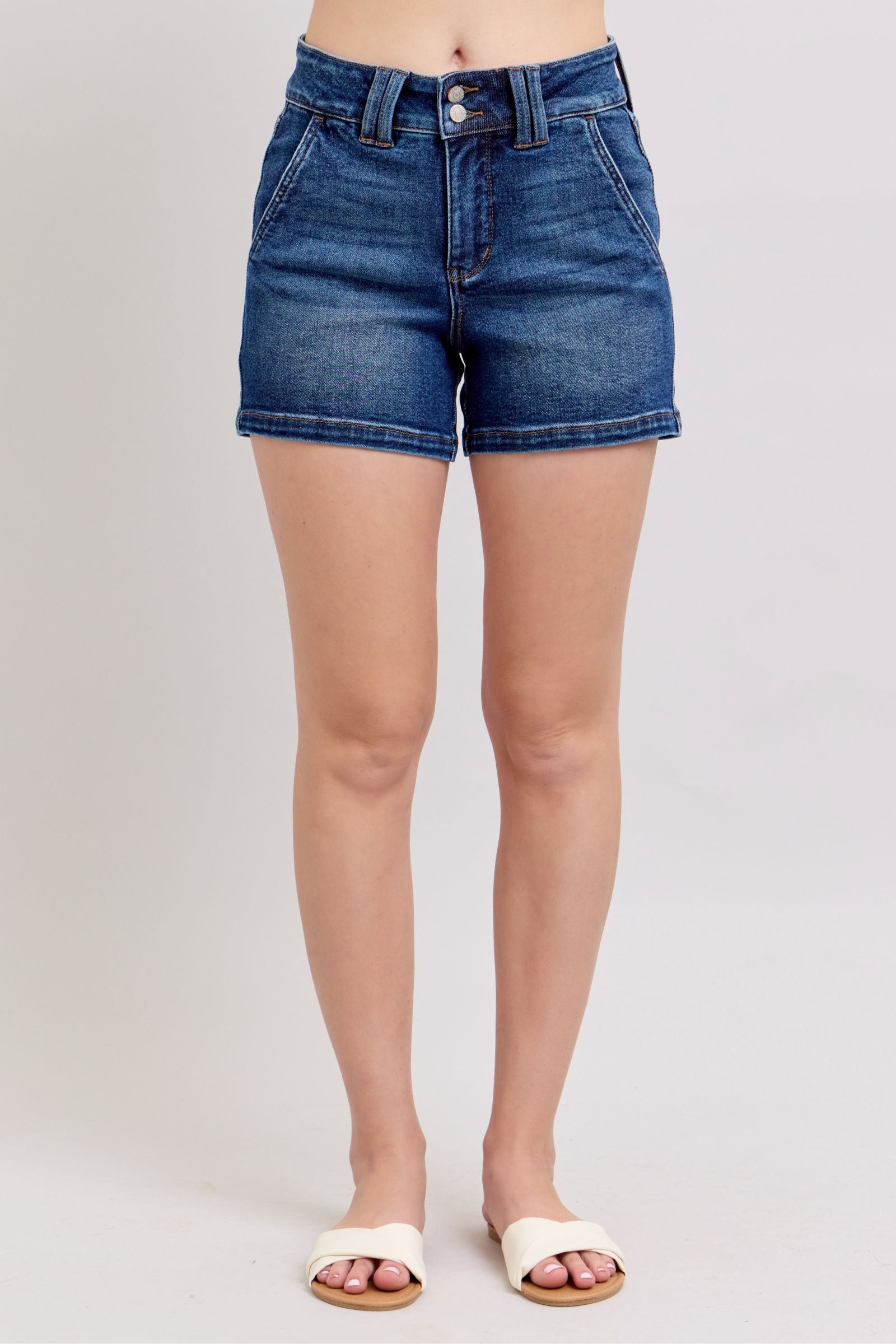 Judy Blue plus size denim shorts with double button waistband, featuring a classic blue wash and frayed hem.
