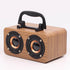 Maroon Asteria portable wooden wireless Bluetooth speaker for outdoor use, with a natural wood finish and compact design.