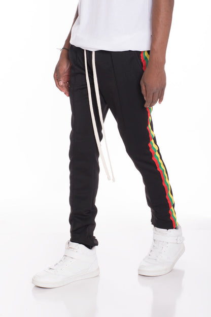 Black Rasta track pants by Lime Milo featuring bold Rastafarian-inspired patterns and comfortable athletic fit.