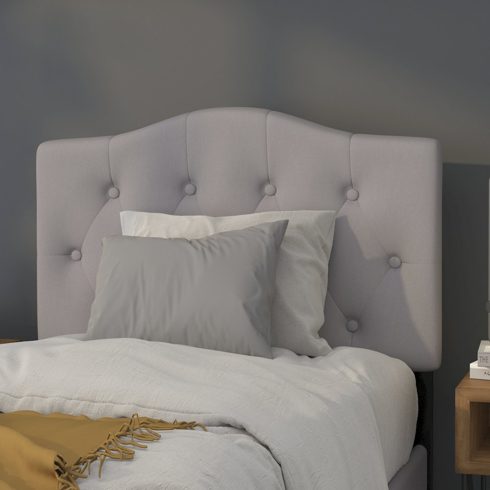 Light gray tufted upholstered twin size headboard in fabric with button detailing, designed for a modern bedroom.