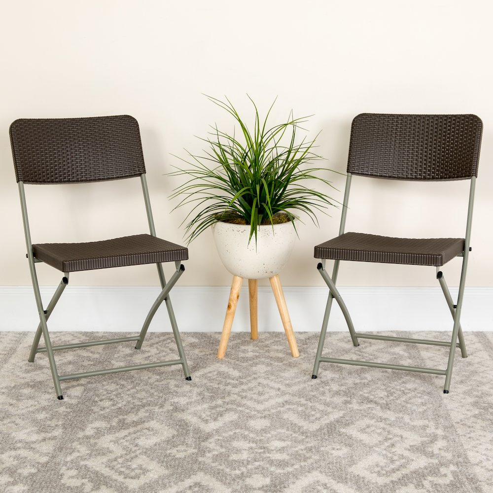 Two brown rattan plastic folding chairs with gray metal frames from the HERCULES Series by Start2Finish, shown folded for storage.