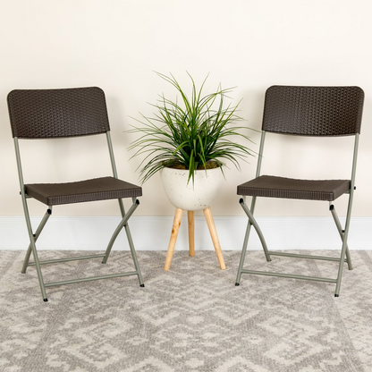 Two brown rattan plastic folding chairs with gray metal frames from the HERCULES Series by Start2Finish, shown folded for storage.
