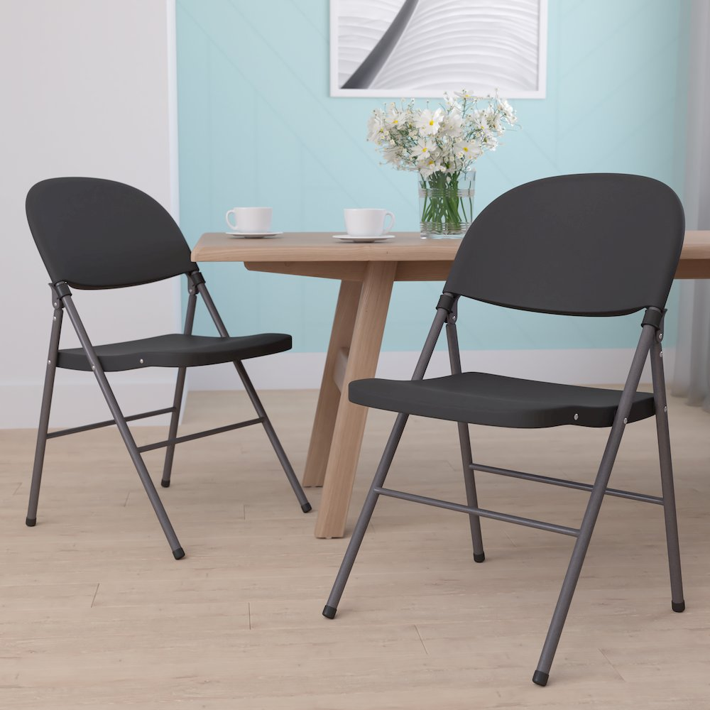 Two black plastic folding chairs with charcoal frames from Hercules Series, rated for 330 lb. capacity, stacked side by side.
