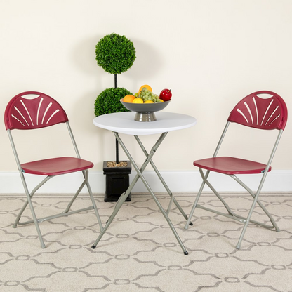 Two burgundy plastic HERCULES Series folding chairs with fan back design, 650 lb. capacity, by Start2Finish, stacked on a plain background.