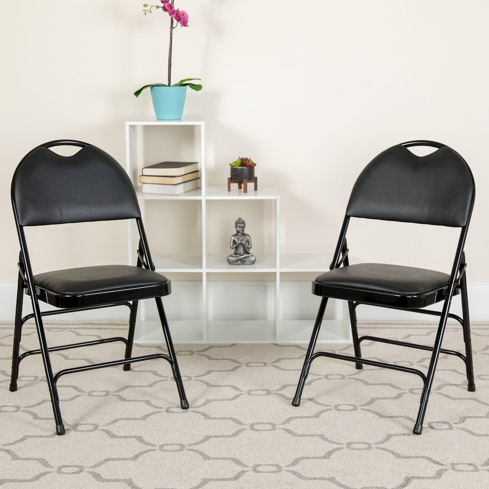Two black vinyl folding chairs from Start2Finish Hercules Series with triple-braced metal frames and easy-carry handles